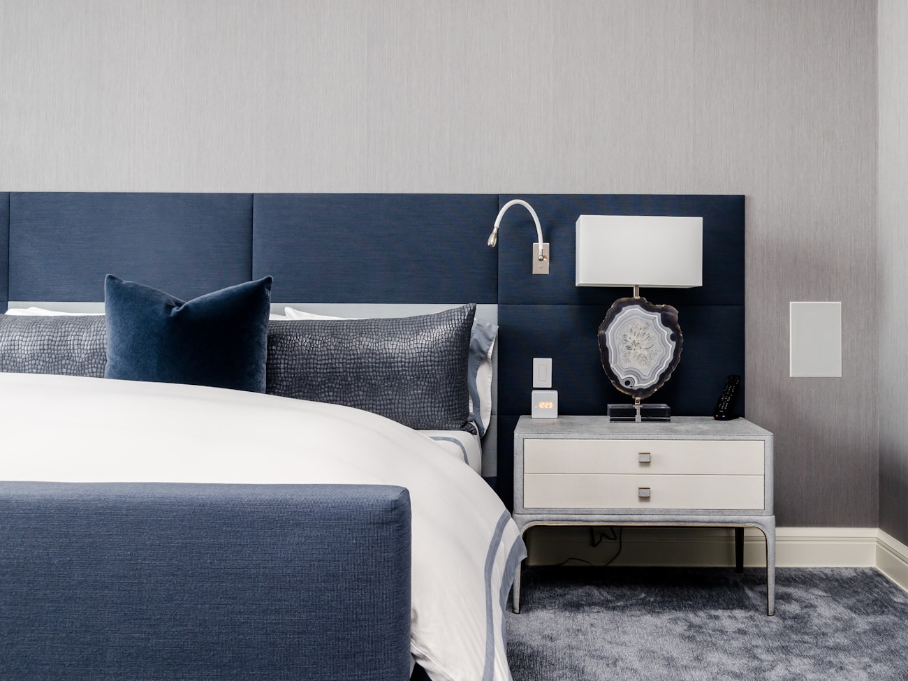 Bedroom with a deep navy decorative accent wall